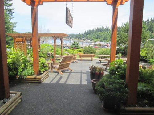 a patio with benches and a gazebo at High Point Resort in Quathiaski Cove