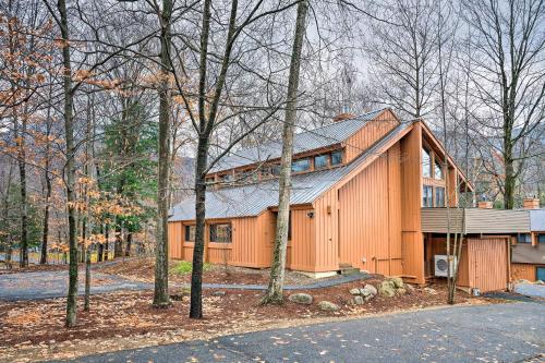 a large orange house in the woods at Village of Loon Condo in Lincoln with Pool Access in Lincoln