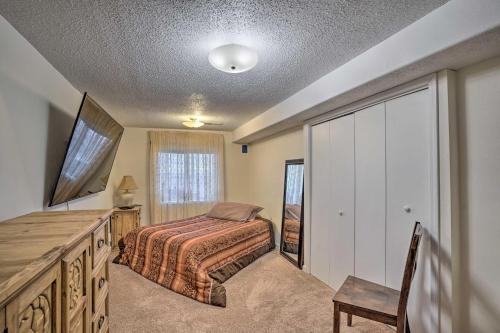 a bedroom with a bed and a dresser and a tv at Williston Apartment with Missouri River Views! in Williston