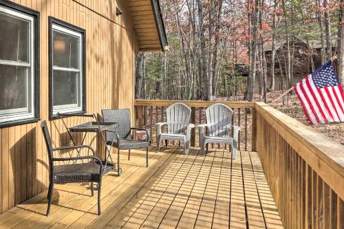 a deck with chairs and a table with an american flag at Fireside Lodge A-Frame in Bryce Resort with Decks in Basye
