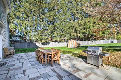 a patio with a table and a grill in a yard at 20 Mi to Philly Inviting Home with Yard in Wayne! in Wayne
