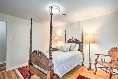 a bedroom with a four poster bed and a chair at 20 Mi to Philly Inviting Home with Yard in Wayne! in Wayne