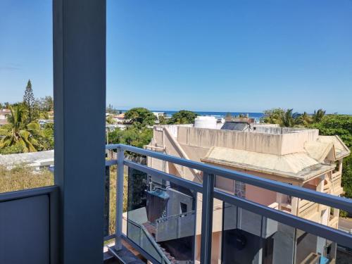 a balcony with a view of a building at Reviva Residence in Blue Bay