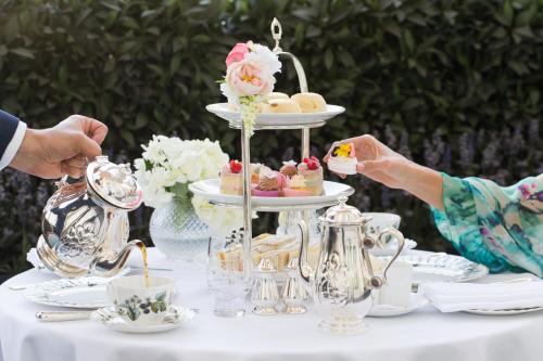 a table with a tea party with a wedding cake at The Lanesborough, Oetker Hotels in London
