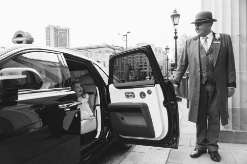 a man is getting out of a car at The Lanesborough, Oetker Hotels in London
