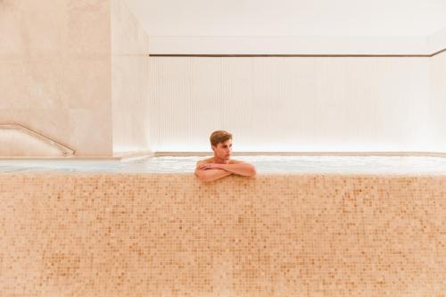 a man standing in a pool of water at The Lanesborough, Oetker Hotels in London