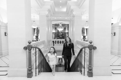 a woman and a little girl walking down the stairs at The Lanesborough, Oetker Hotels in London