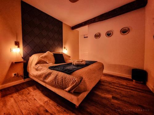a bedroom with a large bed in a room at Logis Sainte Claire in Montauban