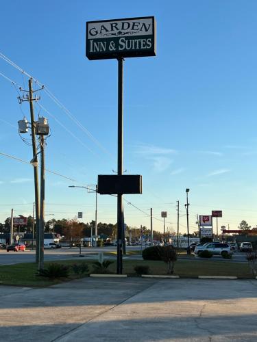 a sign that reads garden inn and suites on a street at Garden Inn & Suites in Metter