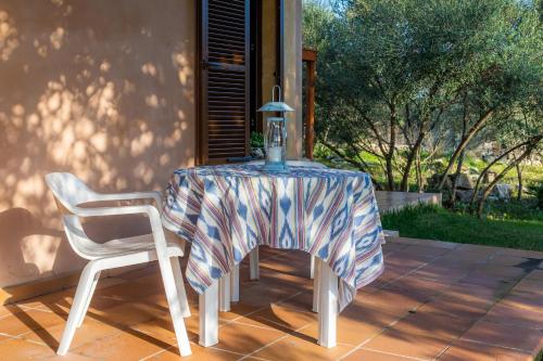 a table and two chairs with a table and a lamp at Villa Toni i María in Capdepera