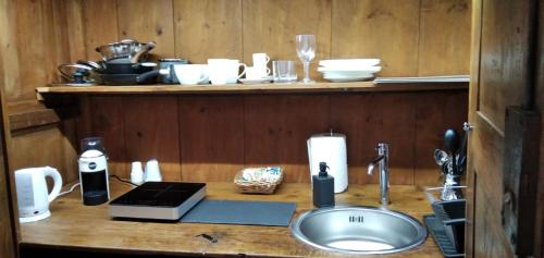 a bathroom counter with a sink and a counter top with dishes at Penta Luxury Room in Matera