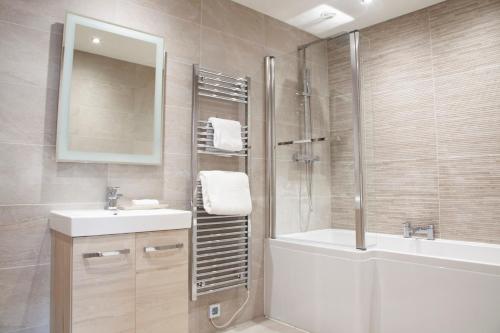 a bathroom with a tub and a sink and a shower at The H Boutique Hotel in Bakewell