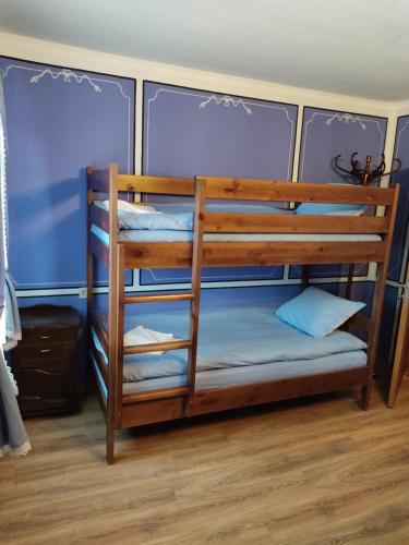 a bunk bed in a room with blue walls at Тороманова къща in Koprivshtitsa