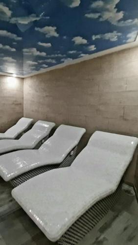 a row of mattresses lined up in a room at Ivkovic spa Milmari N16 in Kopaonik