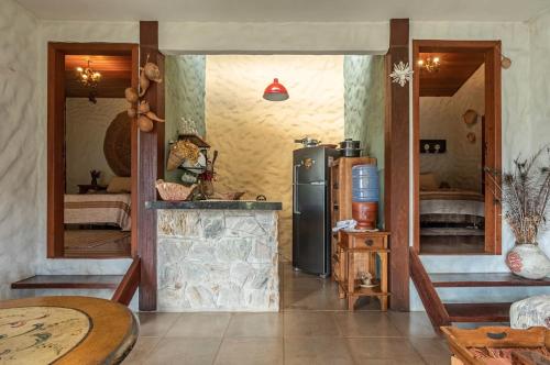 a kitchen with a refrigerator and a table at Sitio Jatoba/Lapinha da Serra in Santana do Riacho