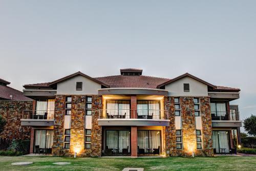 a large brick building with its lights on at Royal Marang Hotel in Phokeng