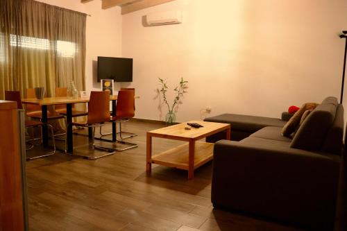 a living room with a couch and a table at Zea Apartments in Himare