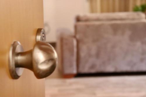 an open door with a metal door knob at Zea Apartments in Himare