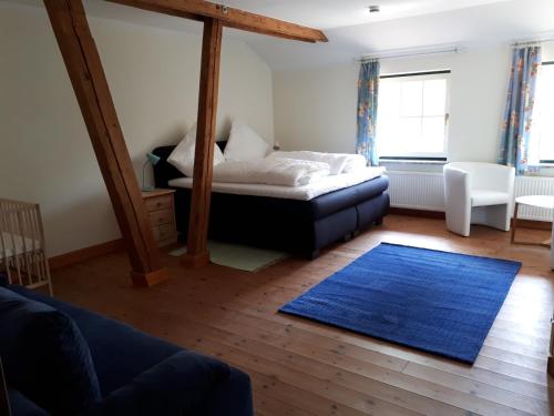 a bedroom with a bed and a blue rug at Kleines Paradies in Krembz