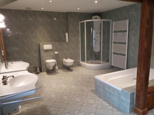 a bathroom with a shower and a tub and a sink at Kleines Paradies 