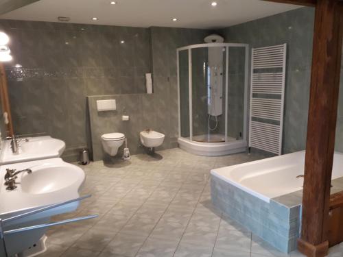 a bathroom with a shower and a tub and a sink at Kleines Paradies in Krembz