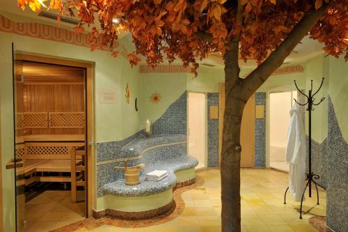 a bathroom with a tree and a bath tub at Hotel Herrschaftstaverne in Haus im Ennstal