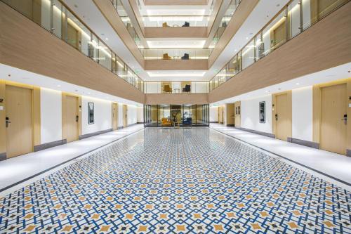 an empty hallway with a tile floor in a building at IKON By Annapoorna in Coimbatore