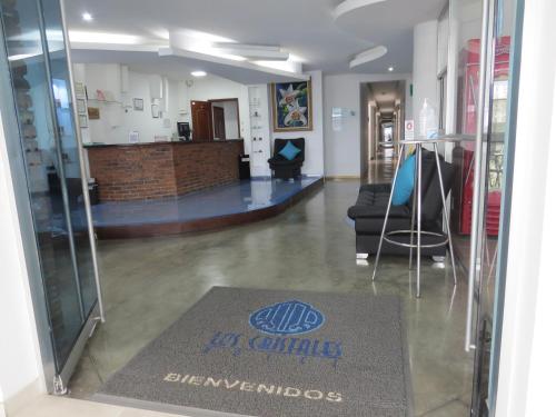 a lobby with a glass door with a sign on it at Hotel Los Cristales in Santa Rosa de Cabal