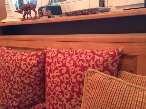 a couple of pillows on a couch with a shelf at Landhausvilla Strittberg 7 in Höchenschwand