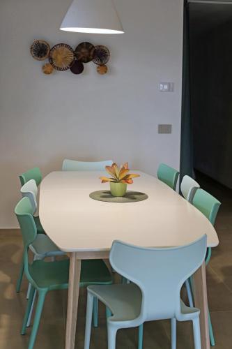 a white table with chairs and a potted plant on it at BELVEDERE CERIEL in Cavaion Veronese