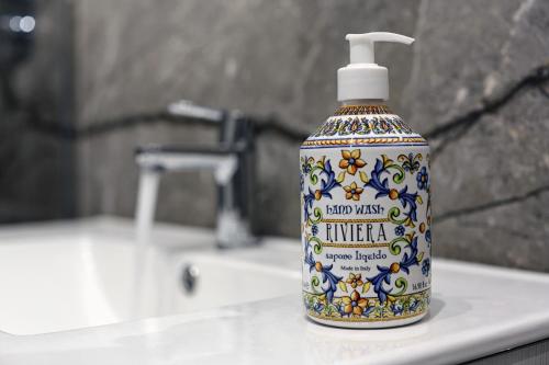 a bottle of hand sanitizer sitting on a bathroom sink at BELVEDERE CERIEL in Cavaion Veronese