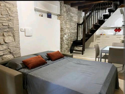 a bedroom with a bed and a staircase at Narnia Loft in Narni