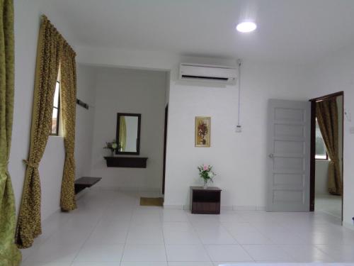 a white room with a door and a mirror at D'View Guest Houses in Kuala Perlis