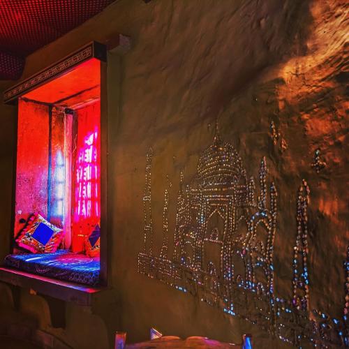 a wall with a painting of a city on it at Mud Mirror Guesthouse in Jaisalmer