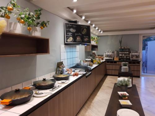a large kitchen with two pans on a counter at Van der Valk Hotel Barcarola in Sant Feliu de Guixols