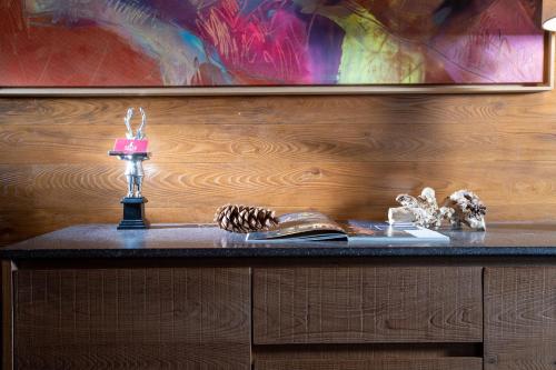 a table with a candle and books on it at Sottovento Luxury Hospitality in Bormio