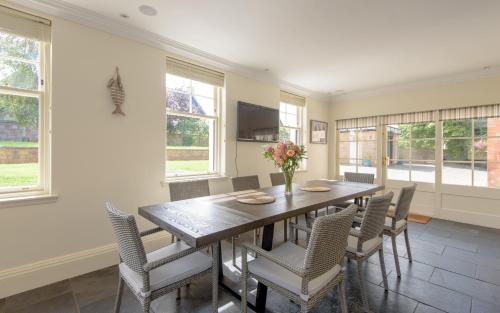 a dining room with a wooden table and chairs at St Aidans in North Berwick