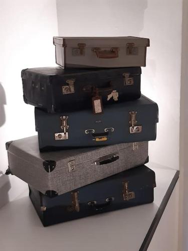 a stack of suitcases stacked on top of each other at The Vault - boutique apartment in the centre of King's Lynn in King's Lynn