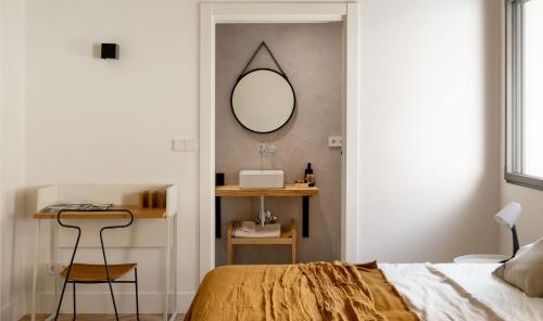 a bedroom with a bed and a mirror on the wall at SOLOA LANDETXEA in Bakio