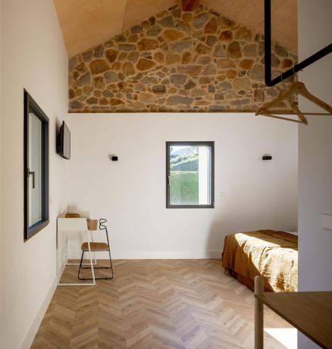 a bedroom with a bed and a desk and a window at SOLOA LANDETXEA in Bakio