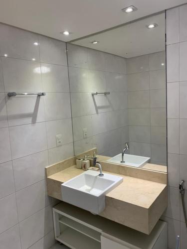 une salle de bain avec un lavabo et un miroir dans l'établissement Apartamento no Aquaville Resort, do lado da sombra e perto da praia, à Aquiraz