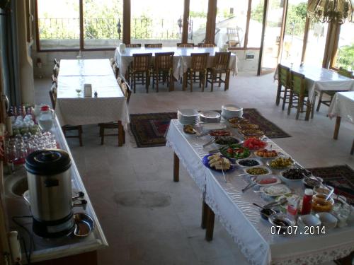 a table with many plates of food on it at Nature Park Cave Hotel in Goreme