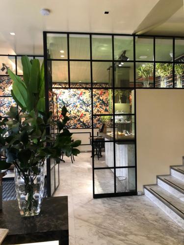 a lobby with a vase with a plant on a table at Hotel Regina in Bogotá