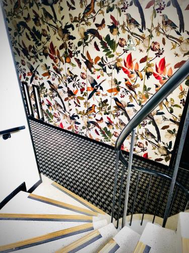 a staircase with a floral patterned wall at Hotel Regina in Bogotá