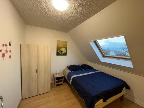 a bedroom with a bed and a window at Maison proche de l'aéroport CDG-Paris in Goussainville