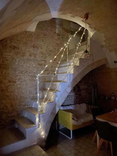 a staircase in a building with lights on it at La Torretta di Gigi - soggiorno in torre medievale in Bisceglie