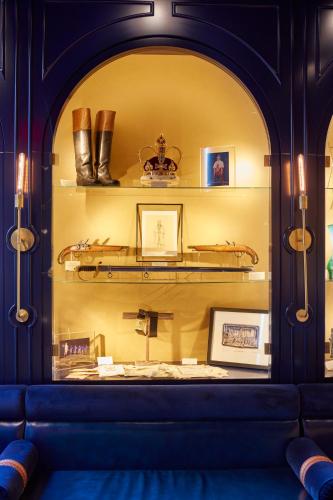a room with a blue couch and shelves with shoes at CIVILIAN Hotel in New York