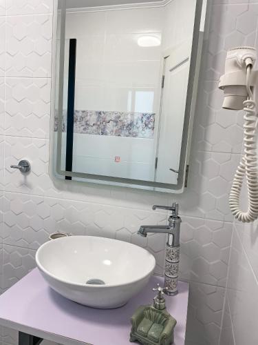 a bathroom with a white sink and a mirror at Transylvania Mountain View CDI in Bran