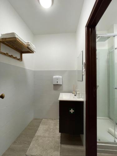 a bathroom with a sink and a shower at PRAÇA AL in São João da Madeira