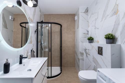 a bathroom with a shower and a sink and a toilet at Dąbska Street Krakow - Luxury Apartments in Krakow
